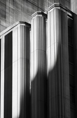 Architectural detail of a building facade with pillars and shadows