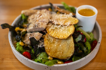 Grilled chicken salad with sauce, on plate for served in a restaurant