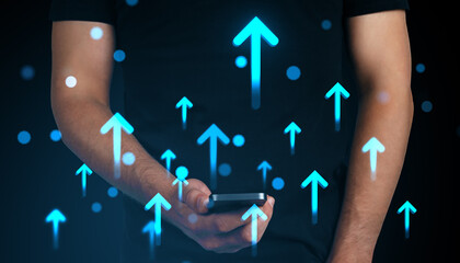 Man holding smartphone with glowing upward arrows symbolizing digital growth, success, and business progress on abstract dark background.