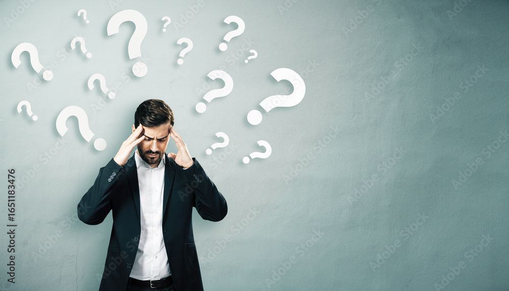 Poster confused businessman touching head with question marks around on light wall, symbolizing decision-ma