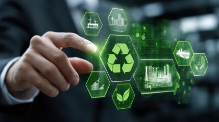 A hand is positioned near digital icons illustrating various sustainable practices like recycling and renewable energy sources in an office environment