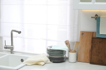 Clean dishware and waffle towel on countertop in kitchen
