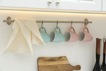 Clean waffle towel and cups hanging in kitchen, closeup