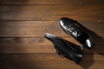 Pair of shoes for tap dance on wooden floor, top view. Space for text