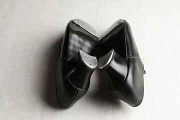 Pair of shoes for tap dance on white wooden floor, closeup