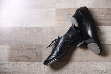 Pair of shoes for tap dance on floor, flat lay. Space for text
