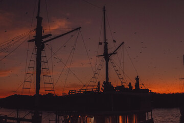 Scenery of large ship in a port at sunset golden hour time.