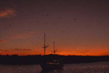 Scenery of large ship in a port at sunset golden hour time.