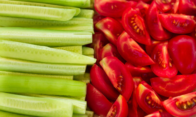 Fresh tomatoes and cucumbers sliced background
