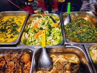 Assorted Vegetarian Dishes Presented in Stainless Steel Serving Trays