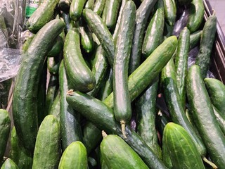 Freshly Harvested Green Cucumbers Piled Together in a Grocery Display