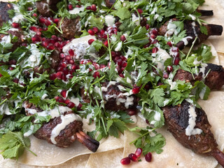 Grilled lamb kebabs with pomegranate and fresh herbs