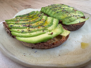Delicious avocado toast with fresh herbs on plate