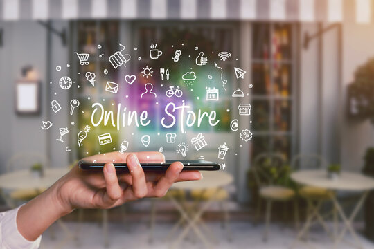 Moblie shopping device app, hand holding smartphone with word writing Special Offer and icons app hologram symbols concept, shop front background