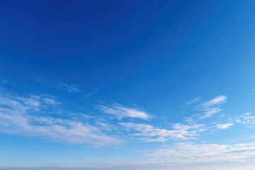 Vibrant blue sky with wispy clouds on a sunny day background