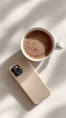 Coffee cup and phone on a light surface