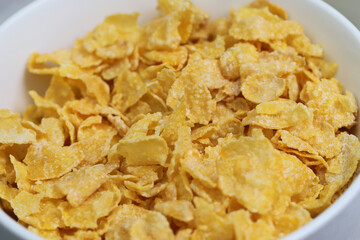 
Yellow frosted corn flakes bowl for dry, cereals breakfast. Healthy food.