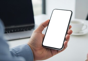 Modern professional using smartphone at desk with laptop and coffee, focusing on technology and productivity