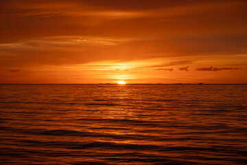 Asnelles-Sur-Mer, France - 08 08 2025: Panoramic view of the sea, waves, artificial port and the colorful cloudy sky at sunset along the jetty