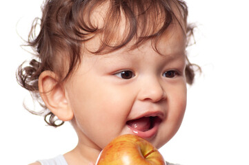 Happy toddler biting and eating delicious and healthy apple