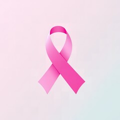 A pink awareness ribbon is displayed on a soft subtly lit gradient background Pink ribbon