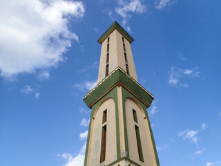 Obraz premium Muslim mosque for prayer and worship of Allah, Omar bin Abdul Aziz Mosque, Jijel State, Algeria, North African mosques in village on Mediterranean coast, Minaret and dome of mosque, Ramadan iftar.
