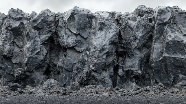 Dramatic, rough, gray rock wall fills the frame, under a cloudy sky - Powered by Adobe