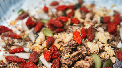 Nutritious yogurt parfait topped with chia seeds, goji berries, and crunchy granola. Perfect for food blogs, healthy eating content, and breakfast photography
