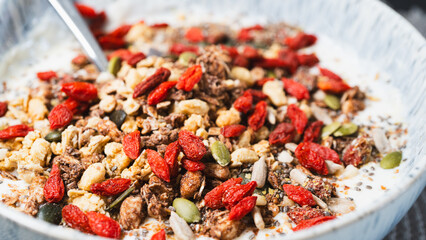 Nutritious yogurt parfait topped with chia seeds, goji berries, and crunchy granola. Perfect for food blogs, healthy eating content, and breakfast photography