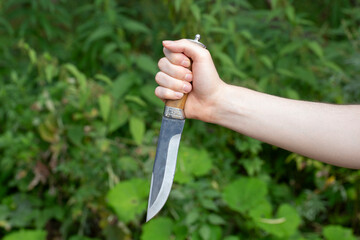 A man with a knife in his hands. Aggression and death threats.