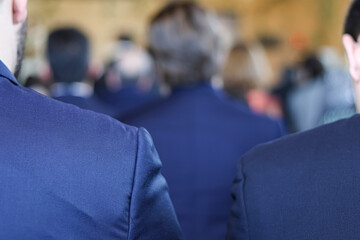 Group or meeting of businessmen in blue suits.