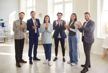 Group of colleagues rejoicing getting promotion, congratulating their partner with business...