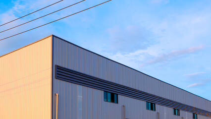 Factory industrial office building with louver ventilation on corrugated steel wall with cable line...