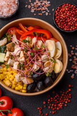 Bowl with chicken pieces, rice, tomatoes, peppers and microgreens. Bowl with chicken