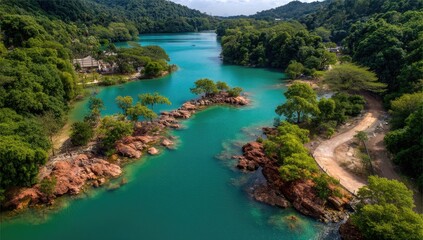Turquoise lake winding through lush tropical landscape