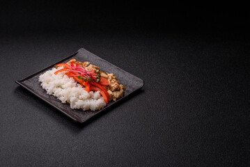 Bowl with chicken pieces, rice, tomatoes, peppers and microgreens. Bowl with chicken