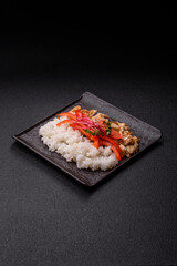 Bowl with chicken pieces, rice, tomatoes, peppers and microgreens. Bowl with chicken