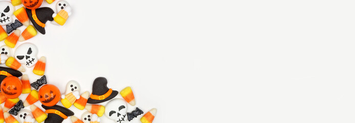 Halloween candy corner border. Overhead view against a white banner background with copy space.