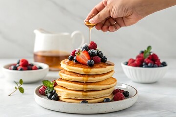 A stack of pancakes topped with fresh berries and maple syrup, drizzled with honey, creating a delicious and visually appealing breakfast or dessert, isolated on white background