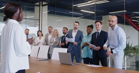 Young african business woman talking with staff at formal meeting briefing, diverse clients, partners listening to boss, ceo team leader on corporate office briefing, multiracial coworkers standing