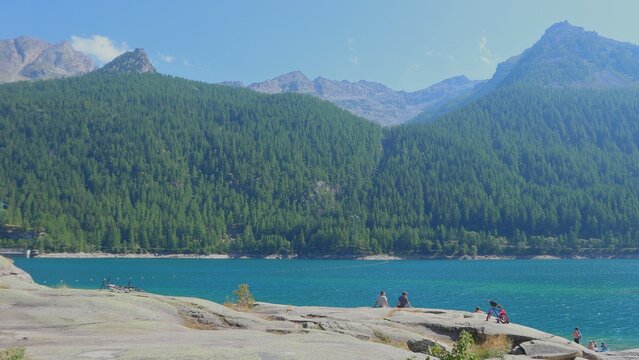 Lake Tahoe in the mountains surrounded by snow-capped peaks, offering a scenic view of the clear water and lush forest landscape - Powered by Adobe