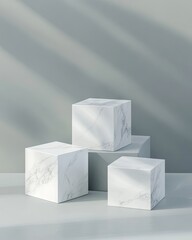 Light grey backdrop with three white marble cubes