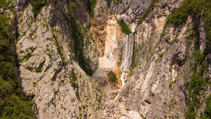 Majestic Mountain Valley with Lush Forests and Rugged Peaks Under a Cloudy Sky