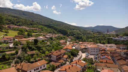 Fototapeta premium Aerial View of a Quaint Town Center with Red Roofs and Nearby River