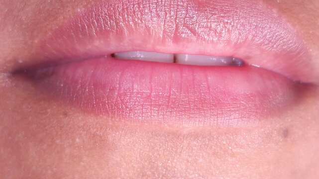 Close up Macro of Indian teenage girl lips doing various types of expressions. lift, Frown, grimace, moue, scowl, pout, Kiss, smooch, smack, peck, graze, caress, skim