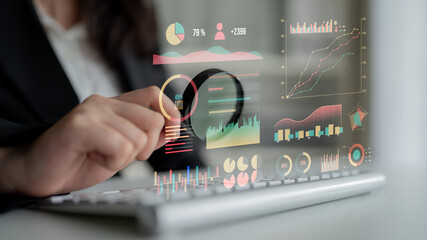 A focused business professional analyzes data on a modern computer, utilizing visual analytics...