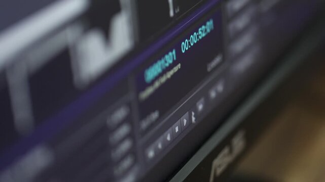 This video showcases a close-up view of a digital editing suite, highlighting a computer screen displaying video editing software. The interface shows a timeline with various clips