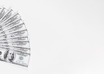 A group of United States hundred dollar bills fanned out on a white isolated background. Suitable...