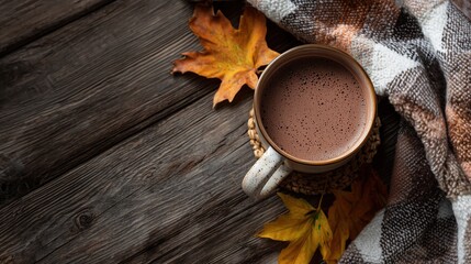 Folded checkered plaid, cup of cacao and fall leaves on wooden background, natural lightning, space for text, top view