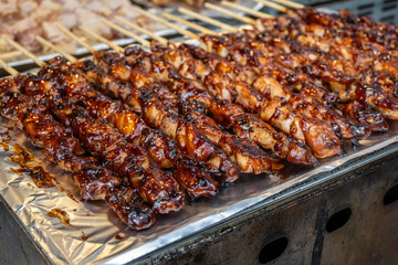 Dakkochi Chicken skewers, a popular Korean street snack, with a sweet and savory sauce. A common treat at markets, reflecting rich culinary heritage.